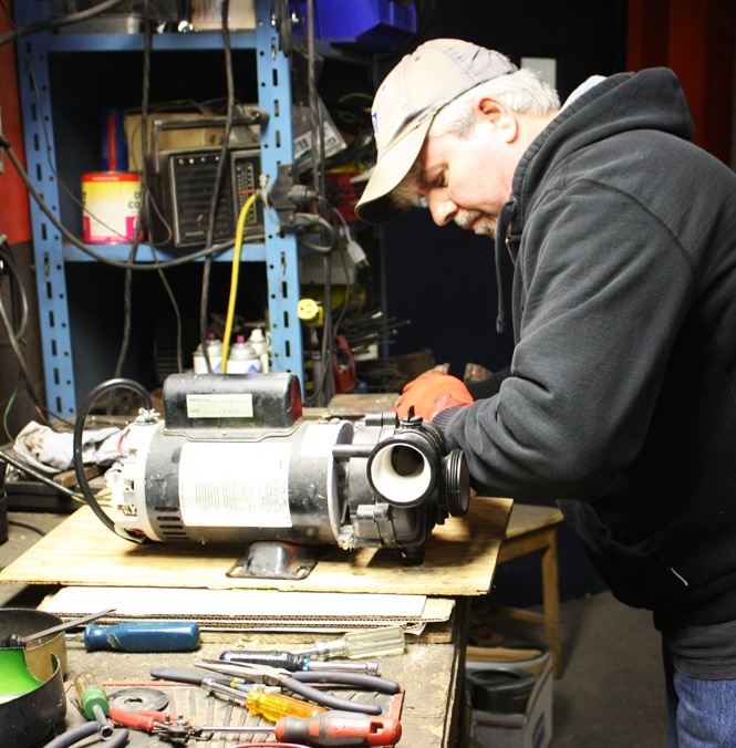 Duke Electric technician repairing motor