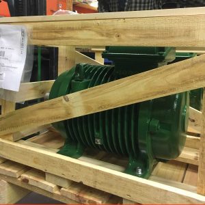 New custom industrial motor in wooden crate on motor shop floor