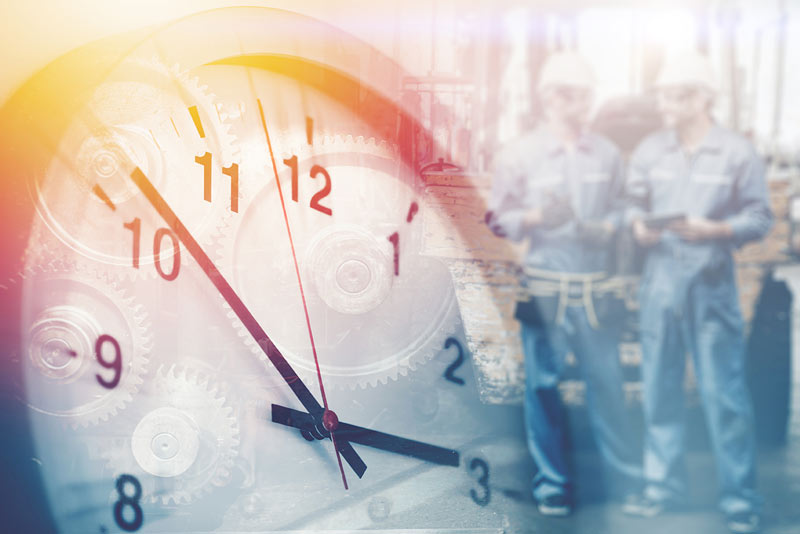 A clock up picture of. a clock with faded out inspectors in the back