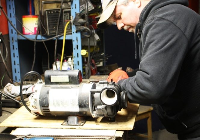 Duke Electric technician repairing motor