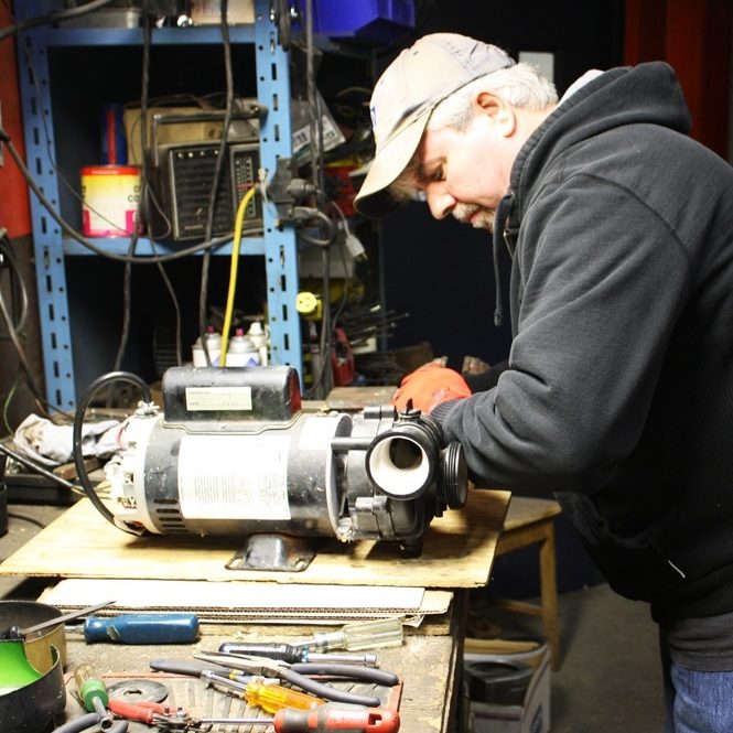 Duke Electric technician repairing motor