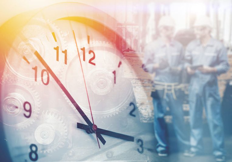 A clock up picture of. a clock with faded out inspectors in the back