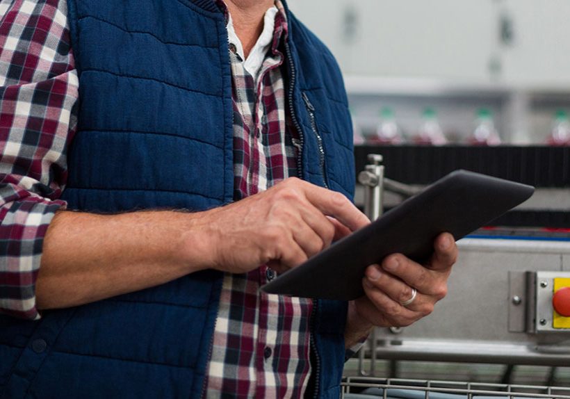 Factory worker reviewing a report
