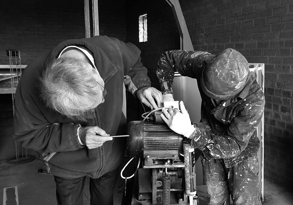 Two men working on a electric motor